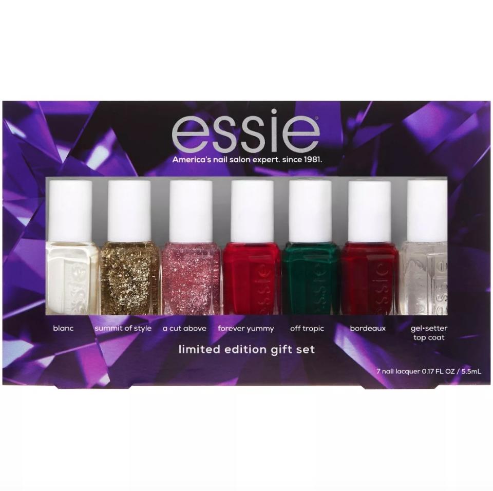 Purple Essie nail kit from left to right: white nail polish, gold glitter, pink glitter, red, green, deep red, clear coat