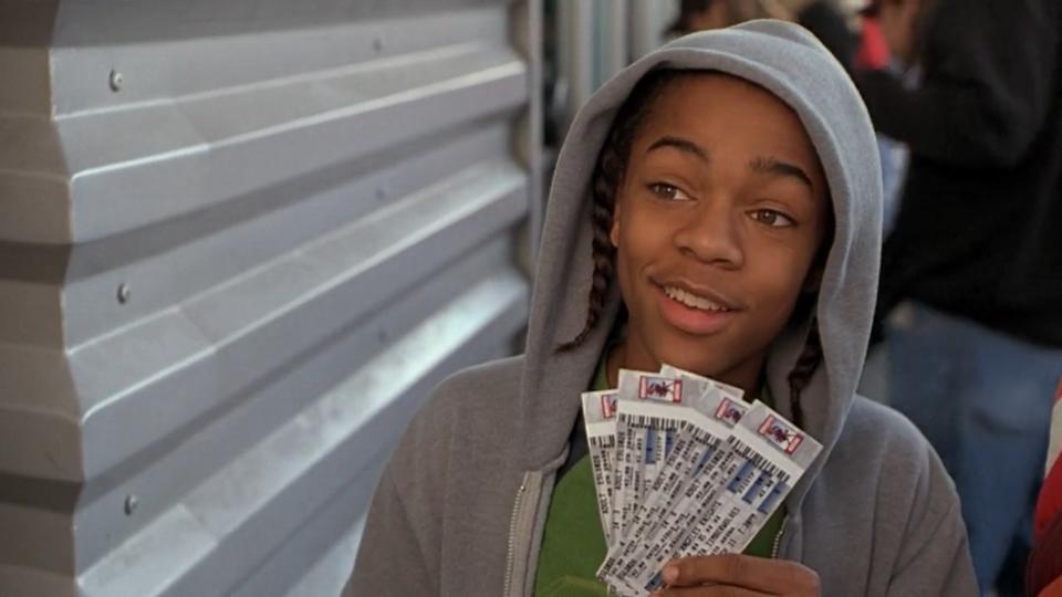 Shad Moss holds up tickets to a basketball game
