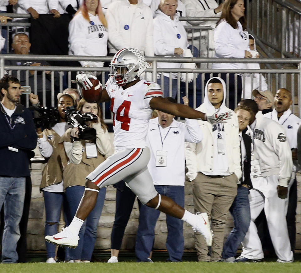 Ohio State's K.J. Hill (14) runs in for a touchdown after a catch against Penn State during the second half of an NCAA college football game in State College, Pa., Saturday, Sept. 29, 2018. Ohio State won 27-26. (AP Photo/Chris Knight)
