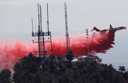 An air tanker drops fire retardant while battling the Wilson Fire near Mount Wilson in the Angeles National Forest in Los Angeles, California, U.S. October 17, 2017. REUTERS/Mario Anzuoni