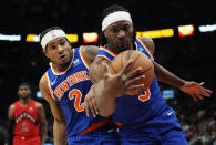 New York Knicks guard Miles McBride (2) and forward Precious Achiuwa (5) chase the ball during the second half of the team's NBA basketball game against the Toronto Raptors on Wednesday, March 27, 2024, in Toronto. (Frank Gunn/The Canadian Press via AP)