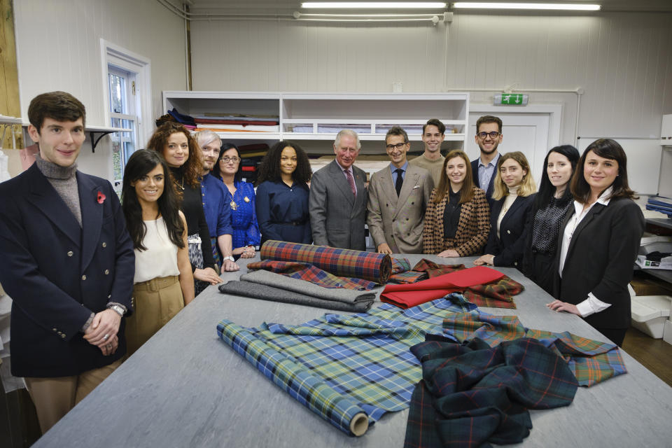 Prince Charles is pictured with Yoox Net-A-Porter chairman Federico Marchetti and students during a visit to Dumfries House in Ayrshire, Scotland, to launch a project for trainee artisans. [Photo: Getty]