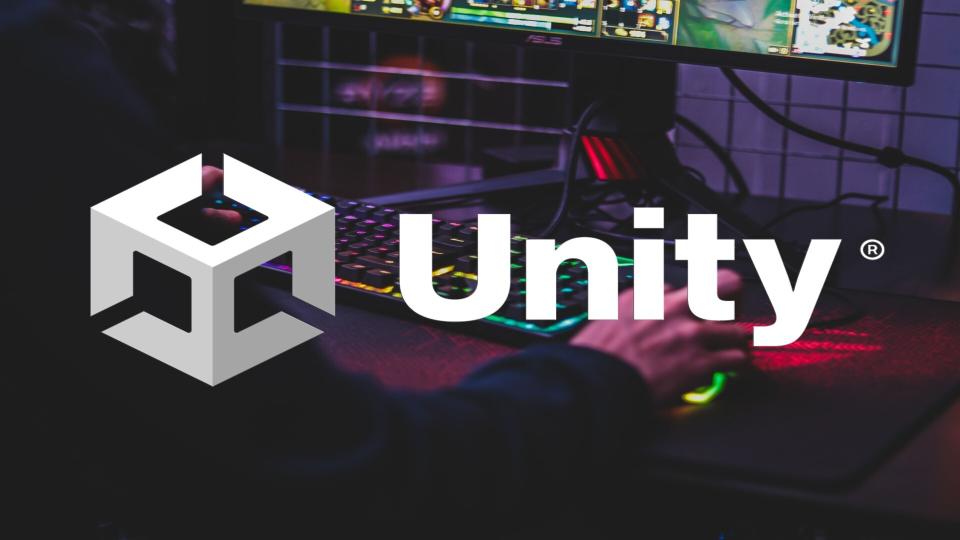  The Unity logo displayed over an image of someone using a mouse and keyboard. 