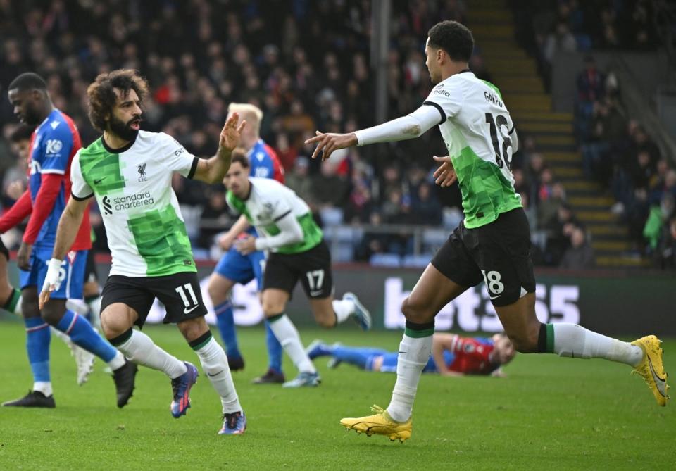 Mohamed Salah celebrates with Cody Gakpo after scoring Liverpool’s first goal (EPA)