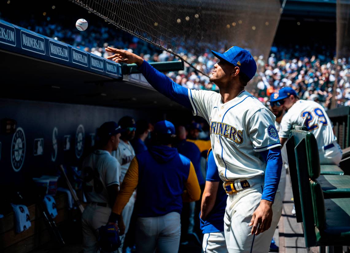 Seattle Mariners center fielder Julio Rodriguez (44) throws a ball back to a fan after signing it before the start of the game at T-Mobile Park on Sunday, July 24, 2022 in Seattle, Wash.
