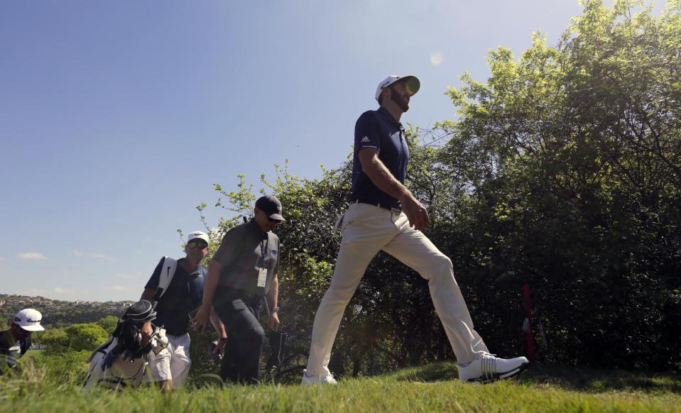 Dustin Johnson, right, walks to the 18th hole during a practice round for the Dell Match Play Championship golf tournament at Austin County Club, Tuesday, March 21, 2017, in Austin, Texas. (AP Photo/Eric Gay)