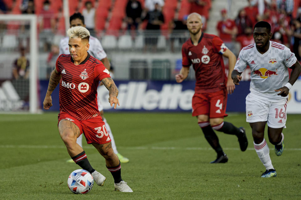 Toronto FC midfielder Yeferson Soteldo (30) moves the ball forward during the first half of an MLS soccer match against the New York Red Bulls on Wednesday, July 21, 2021, in Toronto. (Chris Katsarov/The Canadian Press via AP)