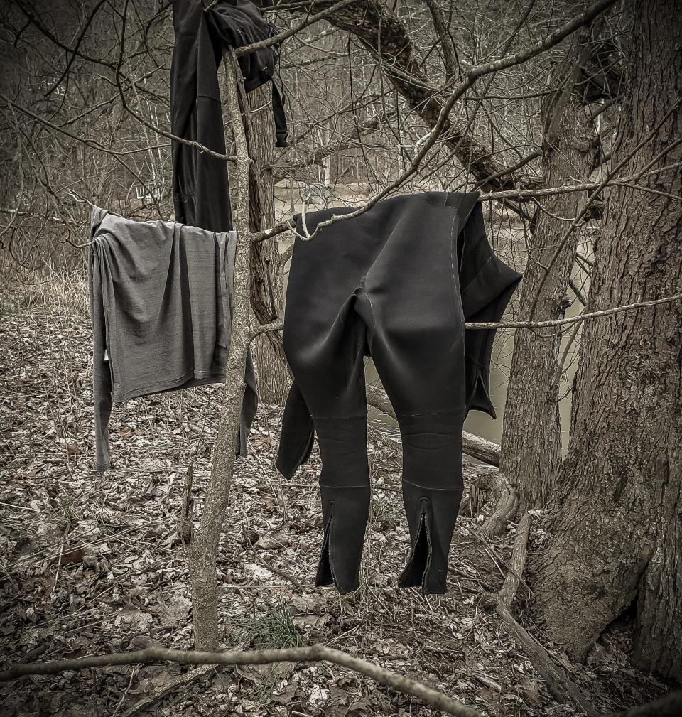 After a day on the river, I draped my wetsuit and other canoeing “day wear” over branches to air them out. Freezing drizzle overnight would coat them with ice.