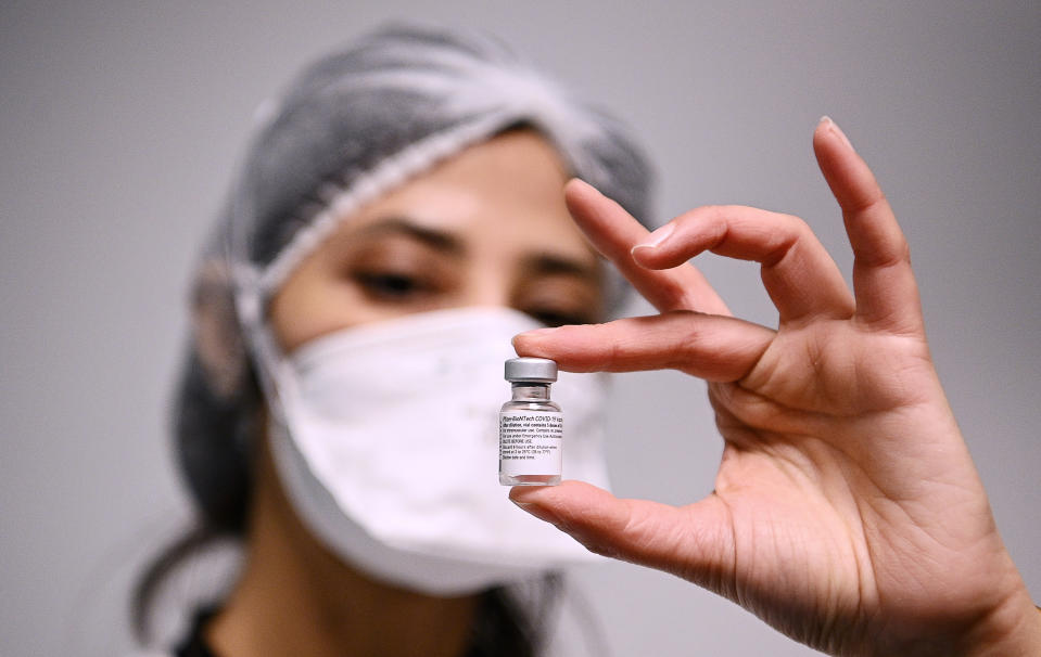 A health worker displays a dose of the Pfizer-BioNTech COVID-19 vaccine at Robert Ballanger hospita in Aulnay-sous-Bois, north of Paris, Wednesday, Jan.6, 2021. Amid public outcry, France's health minister promised Tuesday an "exponential" acceleration of his country's shockingly slow coronavirus vaccination process. (Christophe Archambault/Pool Photo via AP)