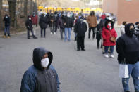 People wait in line for the COVID-19 vaccine in Paterson, N.J., Thursday, Jan. 21, 2021. The first people arrived around 2:30 a.m. for the chance to be vaccinated at one of the few sites that does not require an appointment. (AP Photo/Seth Wenig)