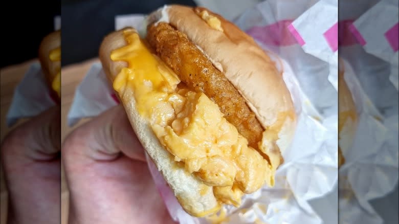 hand holding McDonald's chicken and egg burger