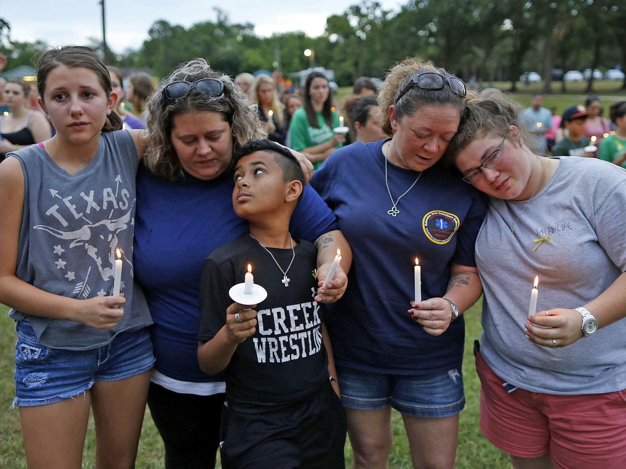 Mourners pray during a vigil in memory of the victims killed in the Santa Fe shooting: Reuters
