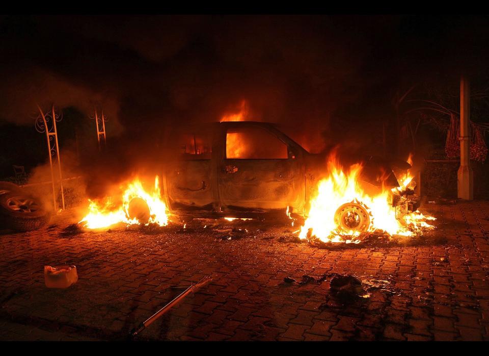 A vehicle and the surrounding area are engulfed in flames after it was set on fire inside the US consulate compound in Benghazi, late on September 11, 2012. (STR/AFP/GettyImages)