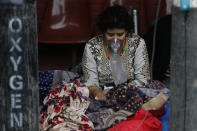 A COVID-19 patient receives oxygen outside an emergency ward at a government run hospital in Kathmandu, Nepal, Wednesday, May 12, 2021. (AP Photo/Niranjan Shrestha)