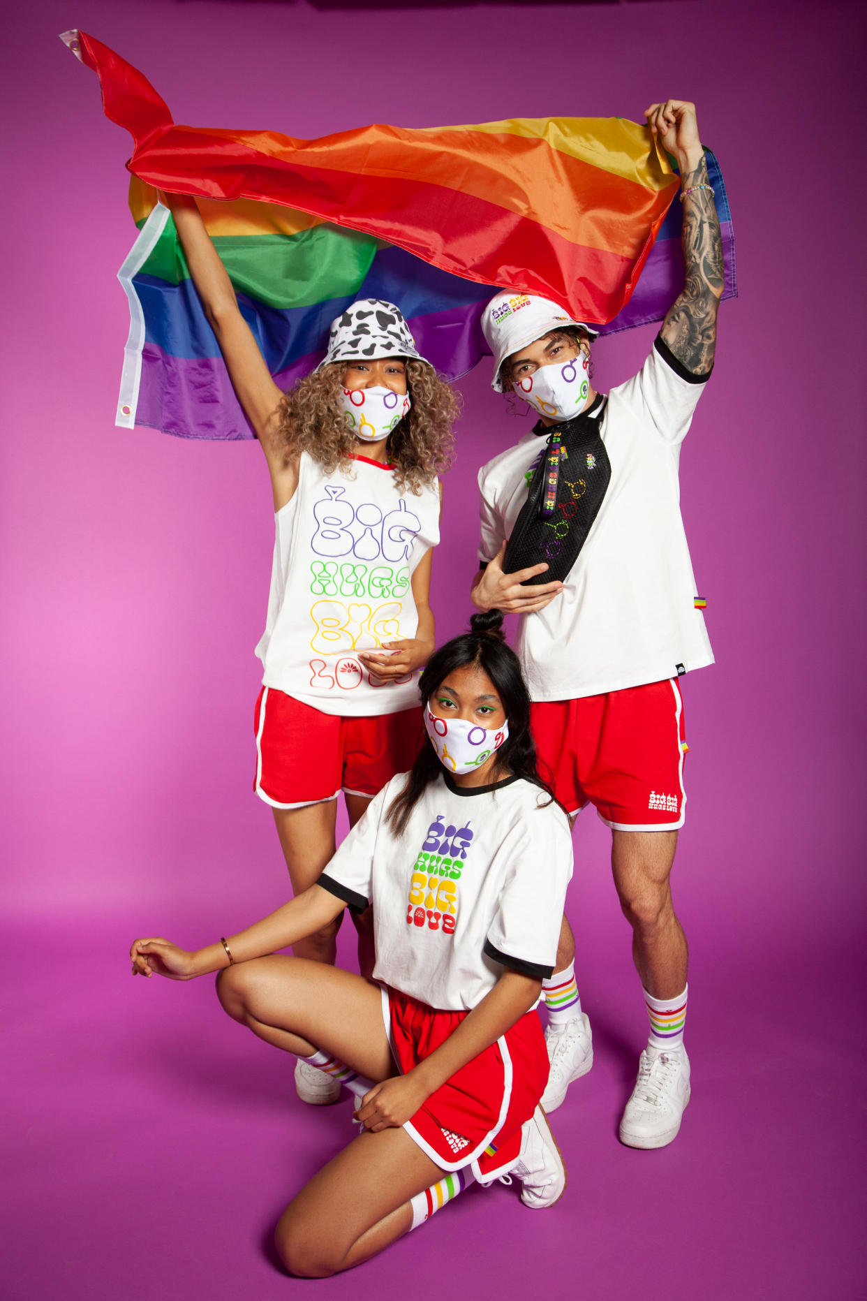 Models pile on some of the new Pride merch — rainbow tube socks, statement tees, red shorts, bucket hats and fanny packs. (Photo courtesy of Teletubbies Pride Collection)