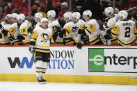 Pittsburgh Penguins center Dominik Simon (12) celebrates his goal with the bench during the second period of an NHL hockey game against the Washington Capitals, Sunday, Feb. 2, 2020, in Washington. (AP Photo/Nick Wass)