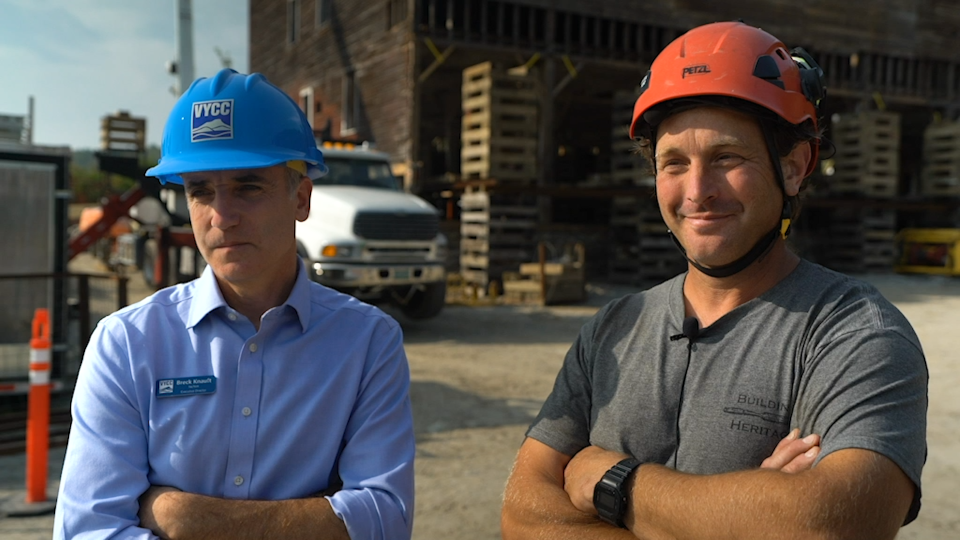 Breck Knauft of Vermont Youth Conservation Corps, left, and Eliot Lothrop of Building Heritage, photographed in front of the East Monitor Barn on Sept. 28, 2023.