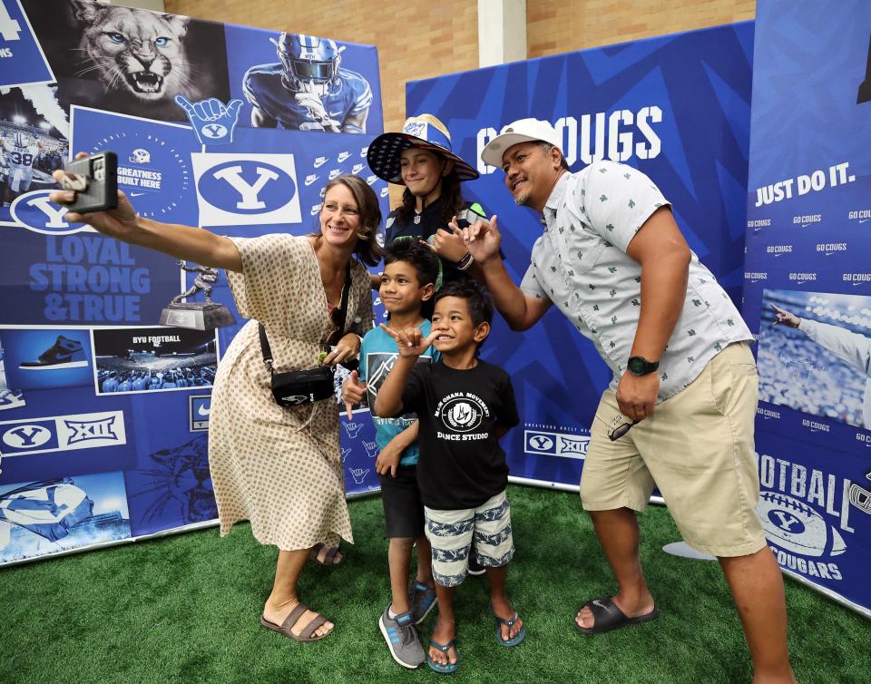 The Fanene family from St. George takes a selfie in the Indoor Practice Facility as BYU holds a party to celebrate their move into the Big 12 Conference with music, games and sports exhibits in Provo on Saturday, July 1, 2023. | Scott G Winterton, Deseret News