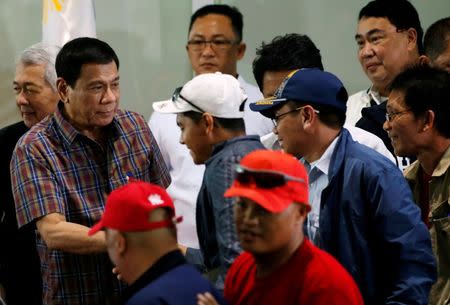 Philippine President Rodrigo Duterte greets Filipino workers who were repatriated by the Philippine government from Saudi Arabia, upon their arrival at the Ninoy Aquino International Airport in Manila, Philippines August 31, 2016. REUTERS/Erik De Castro