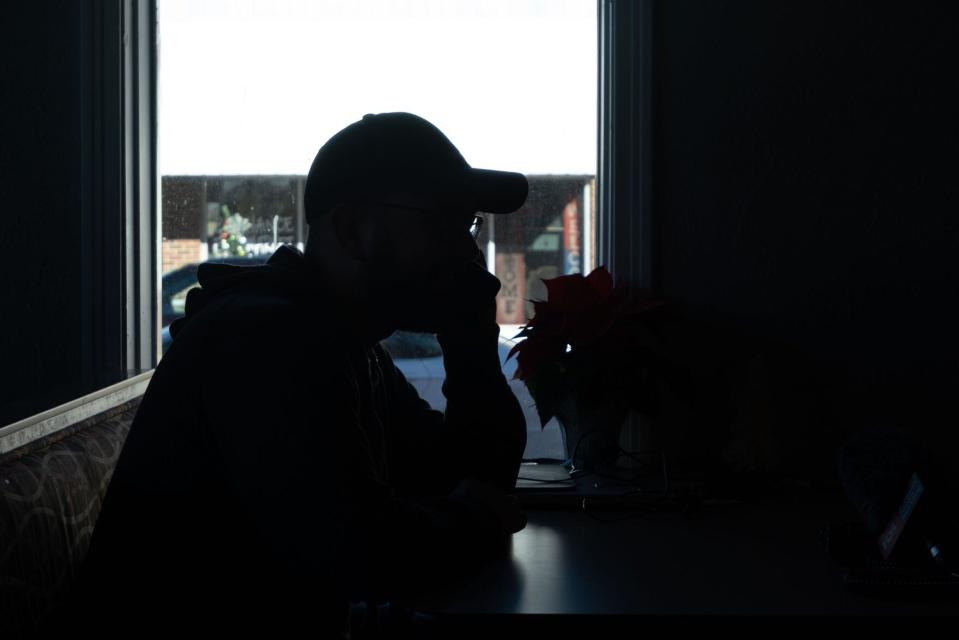 Shandon Classes takes a call from his wife in his coffee shop. The couple opened the store together with hopes of providing their community with a place for people to congregate.