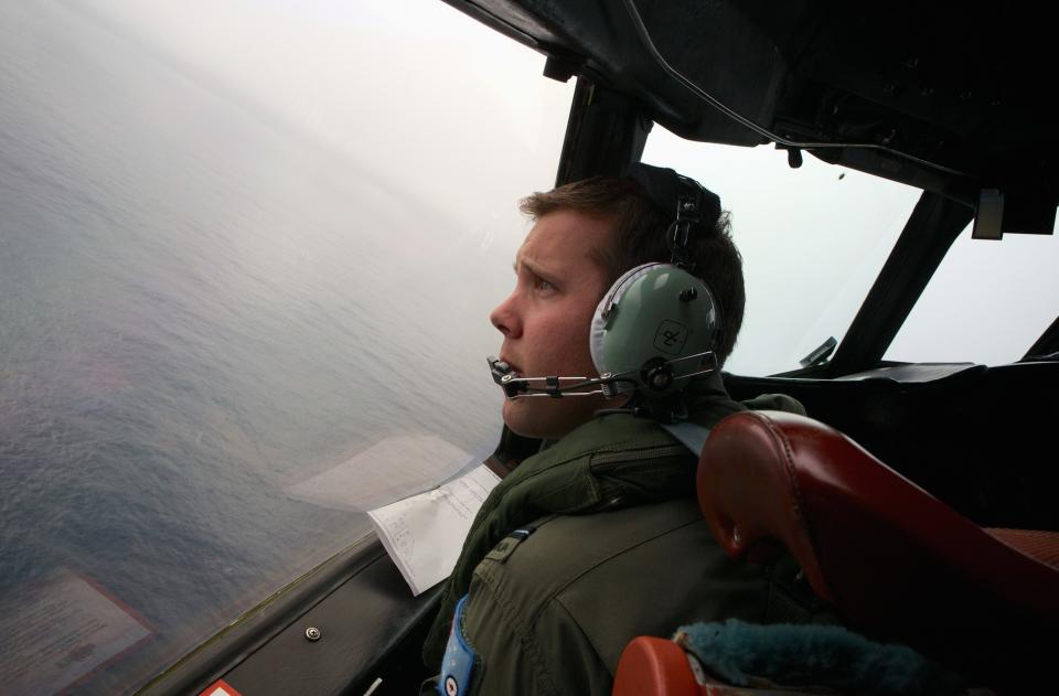 Co-Pilot, Flying Officer Marc Smith, turns his Royal Australian Air Force (RAAF) AP-3C Orion aircraft at low level in bad weather whilst searching for the missing Malaysian Airlines Flight MH370 over the southern Indian Ocean March 24, 2014. An Australian aircraft scouring the southern Indian Ocean for signs of a Malaysia Airlines jet missing for more than two weeks has spotted two new objects, Australian Prime Minister Tony Abbott said on Monday. Abbott told parliament an Australian naval vessel was near where the objects, one circular and greenish grey in colour and the second orange and rectangular, had been seen and hoped to be able to recover them soon. REUTERS/Richard Wainwright/Pool (AUSTRALIA - Tags: MILITARY TRANSPORT)