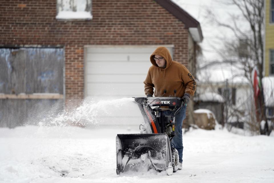 A man blows snow off his driveway onFrancis Avenue in Pittsfield, Mass., on Tuesday, Feb. 28, 2023. As much as 7 or 8 inches (18 to 20 centimeters) of snow blanketed some communities in the Northeast by Tuesday morning.(Ben Garver/The Berkshire Eagle via AP)