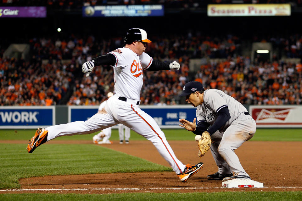 Mark Teixeira #25 of the New York Yankees catches the ball to force out Lew Ford #51 of the Baltimore Orioles in the bottom of the fifth inning during Game One of the American League Division Series at Oriole Park at Camden Yards on October 7, 2012 in Baltimore, Maryland. (Photo by Rob Carr/Getty Images)