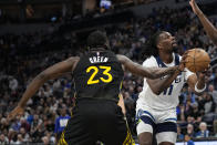 Minnesota Timberwolves center Naz Reid is fouled by Golden State Warriors forward Draymond Green (23) during the first half of an NBA basketball game, Wednesday, Feb. 1, 2023, in Minneapolis. (AP Photo/Abbie Parr)