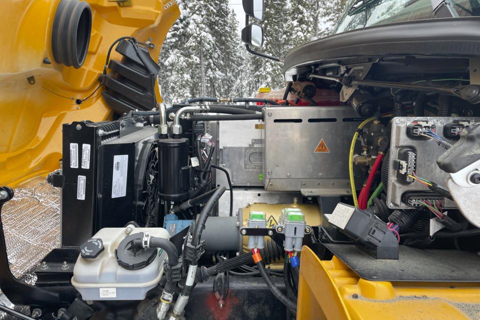 An engine compartment is visible for an electric school bus operating on Feb. 2, 2023, in Tok, Alaska. It works OK on the daily route, but because cold temperatures rob electric vehicle batteries of critical traveling range, No. 50 can't go on longer field trips, nor can it travel to Anchorage or Fairbanks if it needs repairs. It's the same problem that owners of electric passenger vehicles and transit officials are finding in cold climates worldwide. (AP Photo/Mark Thiessen)