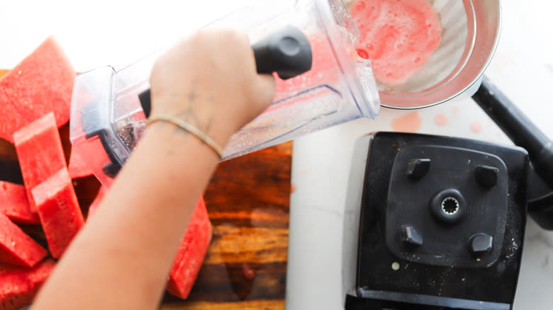 Straining agua fresca through sieve