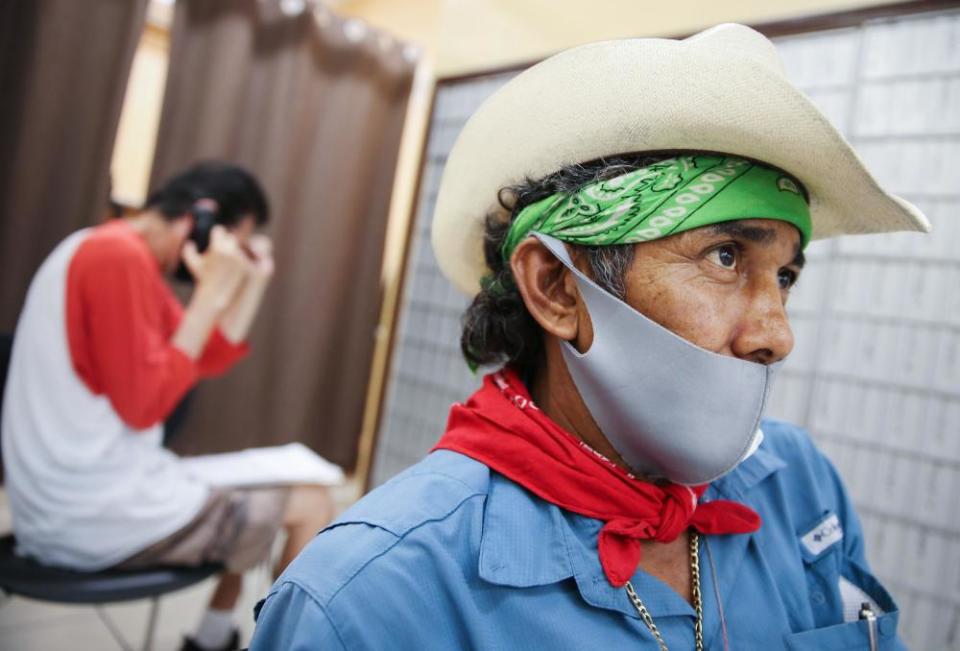 Faustino waits after filling out unemployment forms in a bookkeeping shop in Imperial county in California.