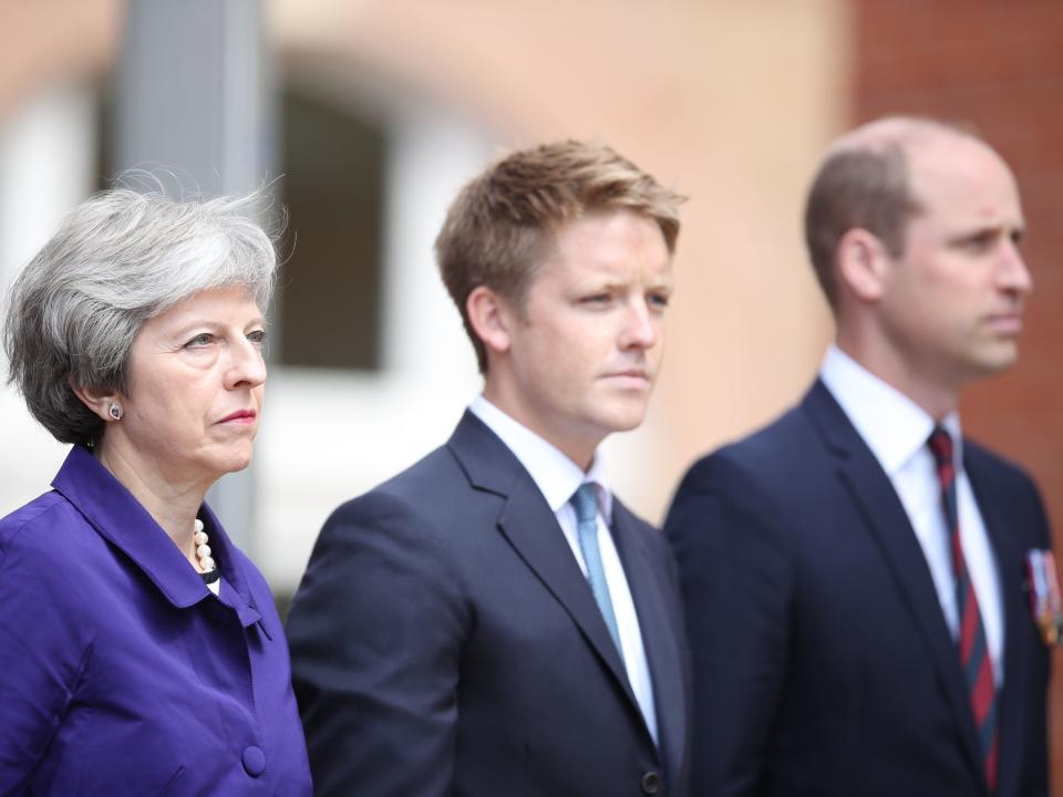 Theresa May standing with Hugh Grosvenor and Prince William outside of a building.