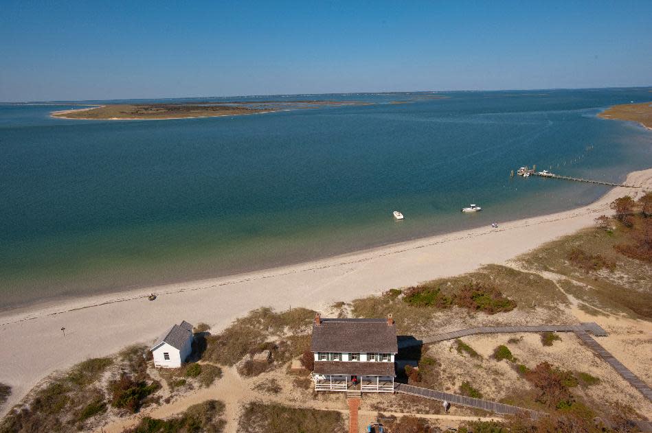 In an undated photo provided by VisitNC.com., a view from the top of the Cape Lookout Lighthouse shows the eastern end of Shackleford Banks, part of the Cape Lookout National Seashore. Beach communities and environmentalists are pushing back against a proposal to give the National Park Service the option of using sand to fight erosion on North Carolina's pristine Shackleford Banks. (AP Photo/VisitNC.com.,Bill Russ)