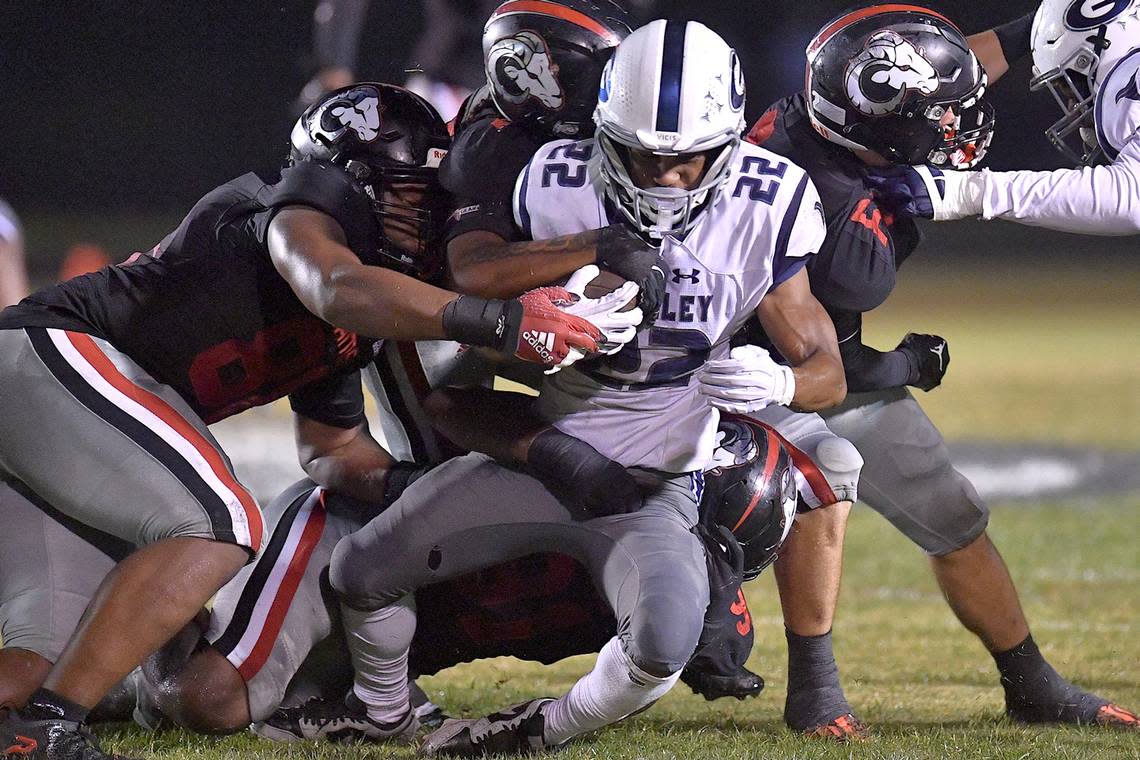 The Rolesville defense takes down Grimsley running back Mitchell Summers (22) during the first half. The Rolesville Rams and the Greensboro Grimsley Whirlies met in a non-conference football game in Rolesville, N.C. on August 30, 2024.