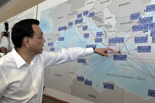 Chinese Prime Minister Li Keqiang looks at a shipping routes map at the port of Piraeus, where Chinese shipping giant Cosco controls two of the three container terminals, on June 20, 2014. Li is in Greece on a three day official visit during which both sides are expected to sign bilateral agreements. AFP PHOTO / POOL /LOUISA GOULIAMAKI        (Photo credit should read LOUISA GOULIAMAKI/AFP via Getty Images) (Photo: LOUISA GOULIAMAKI via Getty Images)