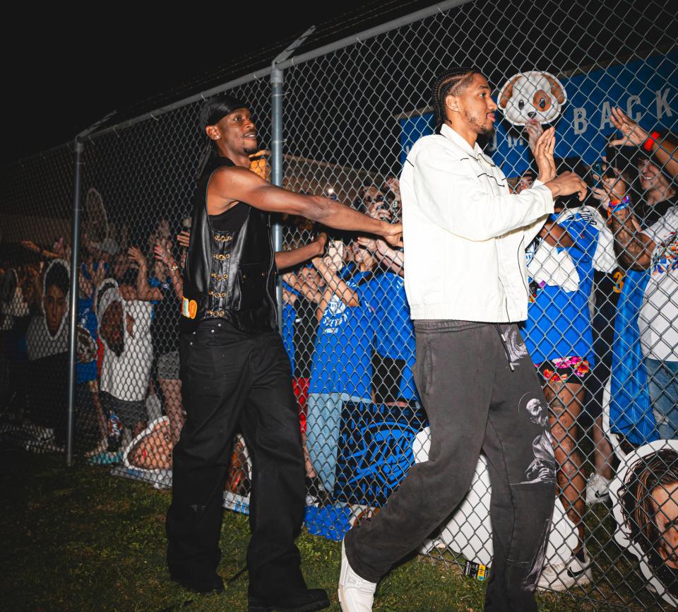 Shai Gilgeous-Alexander, left, and Aaron Wiggins high-five fans at Will Rogers World Airport on Saturday after the Thunder's road loss to the Mavericks in Game 6 of the Western Conference semifinals Saturday night.