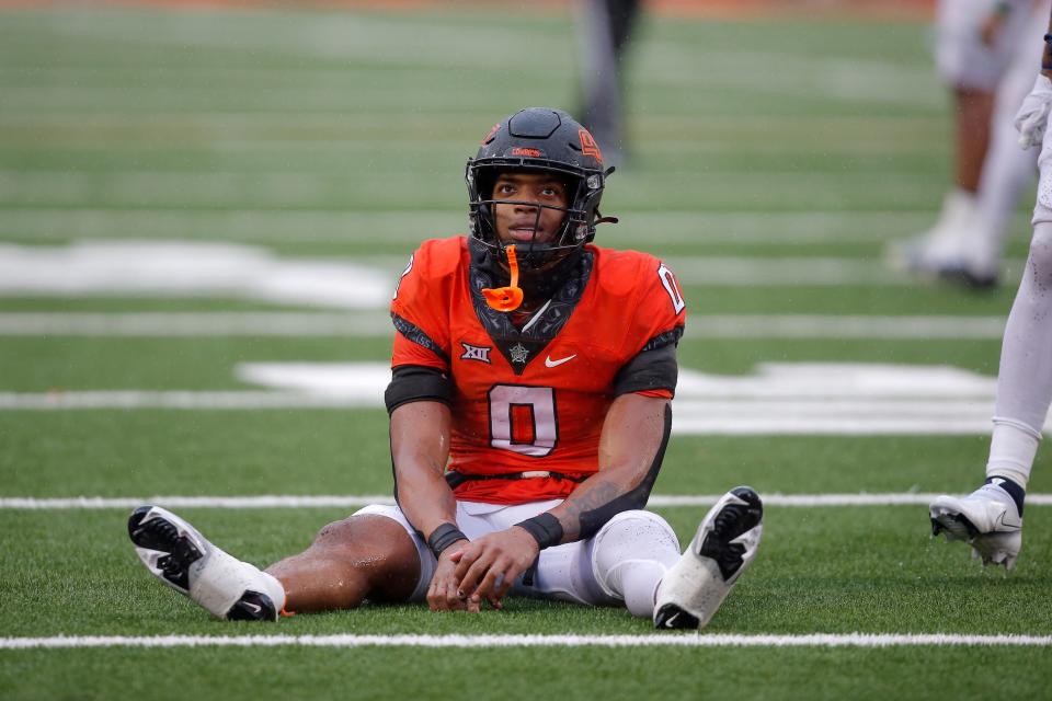 Oklahoma State running back Ollie Gordon (0) sits on the ground after the Cowboys were stopped on a fourth down late in a 24-19 loss to West Virginia on Saturday in the regular-season finale at Boone Pickens Stadium in Stillwater.