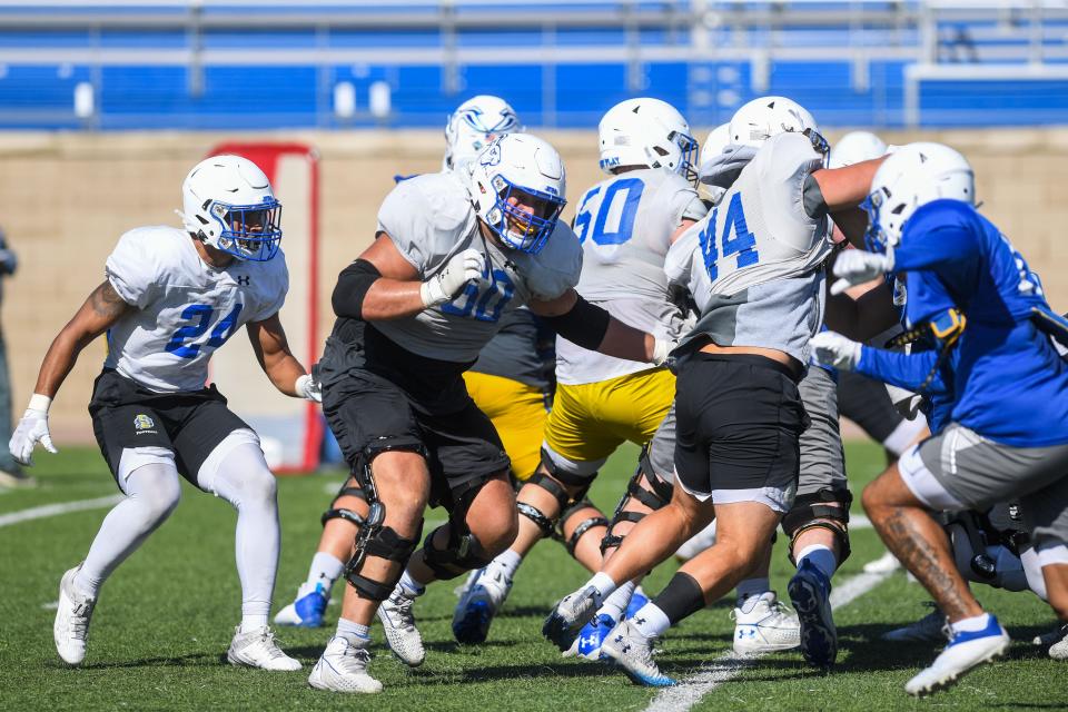 Mason McCormick (60) defends during practice at Dana J. Dykhouse Stadium in Brookings, South Dakota on Monday, August 14, 2023.