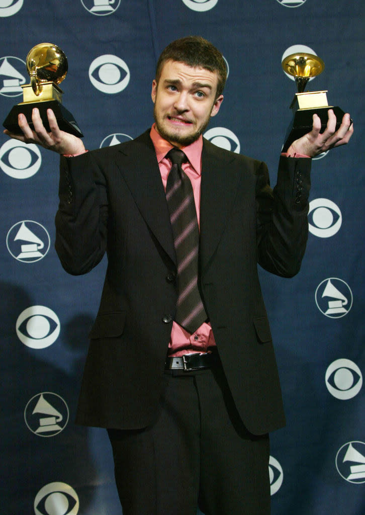 justin holding two grammys