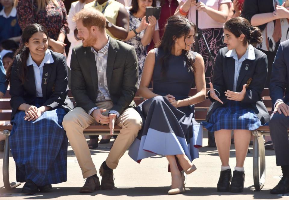 Meghan's dress perfectly matched the school's colour scheme (AFP/Getty Images)