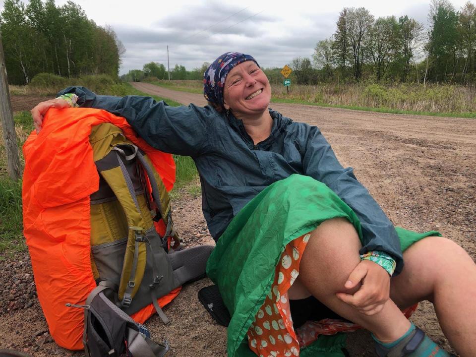Arlette Laan rests along a dirt road while hiking the Ice Age Trail through northern Wisconsin in May 2022. Laan is hoping to hike the entire trail and become the first woman to hike all 11 national scenic trails.
