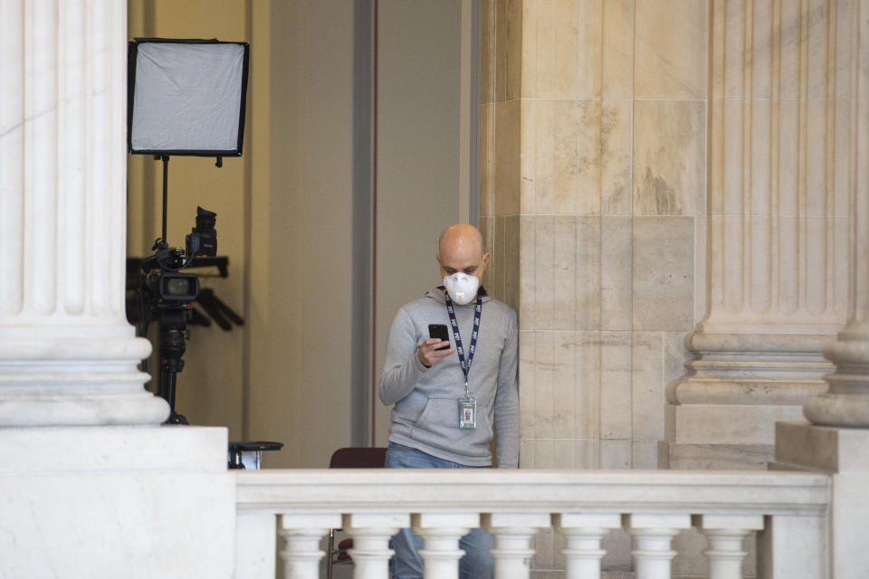 UNITED STATES - MARCH 23: A broadcast news cameraman wears a mask in the Russell Rotunda on Monday, March 23, 2020. (Photo by Caroline Brehman/CQ-Roll Call, Inc via Getty Images)