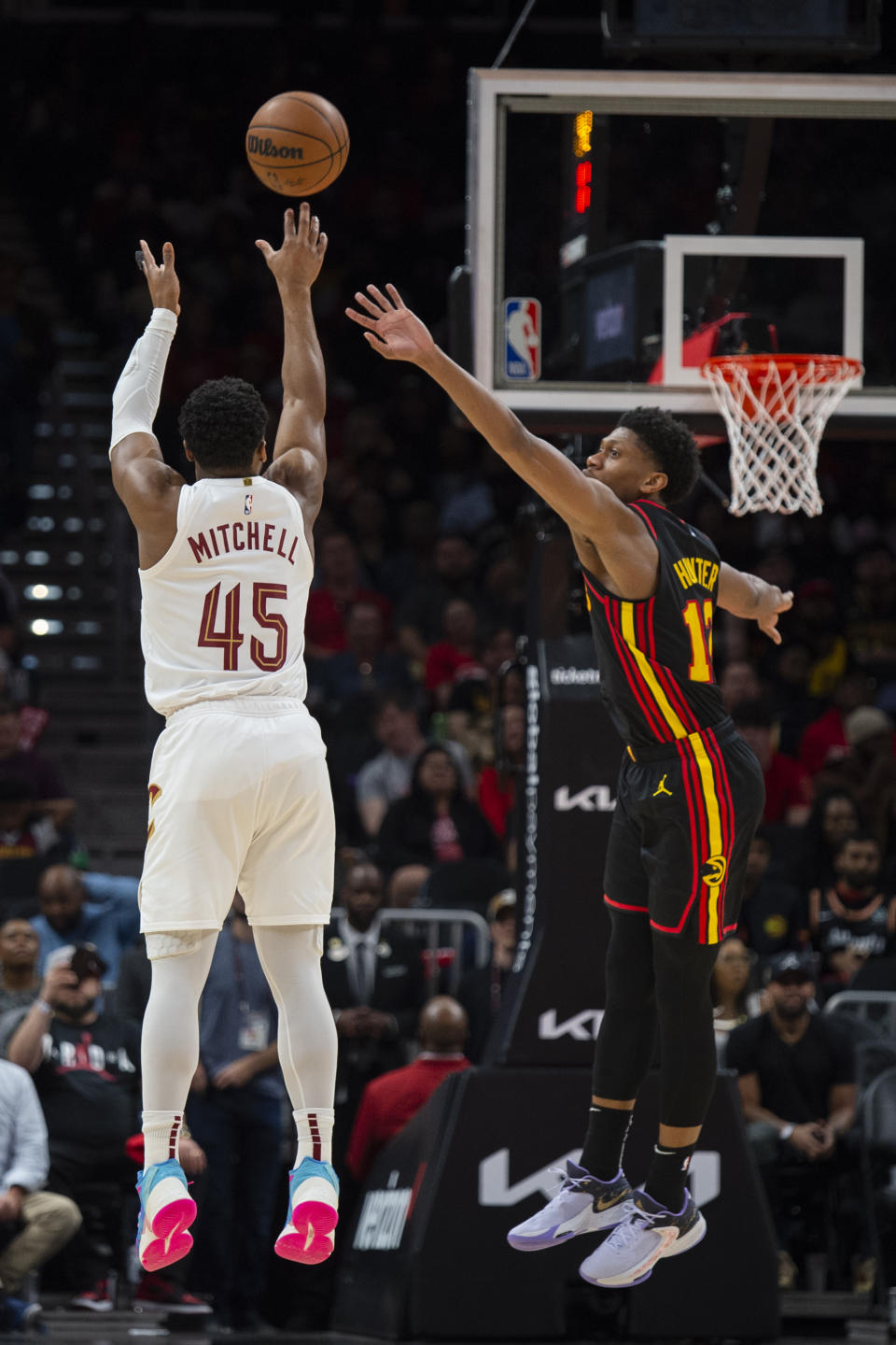 Cleveland Cavaliers guard Donovan Mitchell shoots a 3-pointer against Atlanta Hawks forward De'Andre Hunter during the first half of an NBA basketball game Tuesday, March 28, 2023, in Atlanta. (AP Photo/Hakim Wright Sr.)