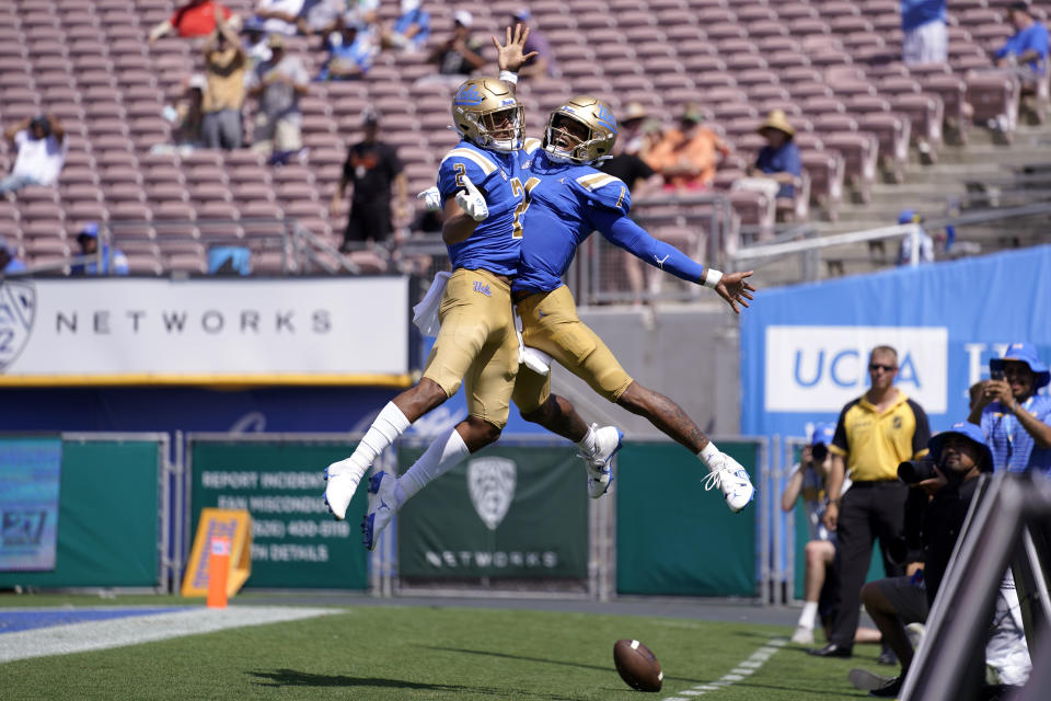 UCLA quarterback Dorian Thompson-Robinson, right, and wide receiver Titus Mokiao-Atimalala celebrate after Thompson-Robinson ran the ball in for a touchdown during the second half of an NCAA college football game against Bowling Green Saturday, Sept. 3, 2022, in Pasadena, Calif. (AP Photo/Mark J. Terrill)