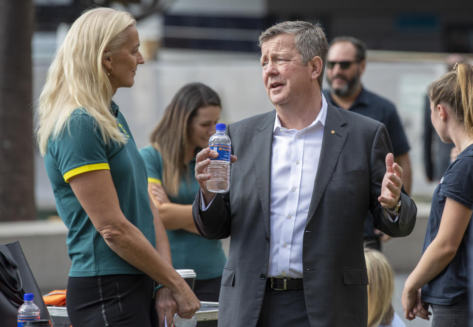 Matt Carroll, right, CEO of the Australian Olympic Committee, chats with former Australian Olympic beach volleyballer and gold medalist Kerri Pottharst at a ceremony to mark 100 days before the start of the Tokyo Olympics in Sydney Wednesday, April 14, 2021. Olympics live sites will be held across Australia during the Olympic Games, from July 23 to Aug. 8 2021, taking advantage of the one hour time zone difference for Australians to watch athletes perform. (AP Photo/Mark Baker)