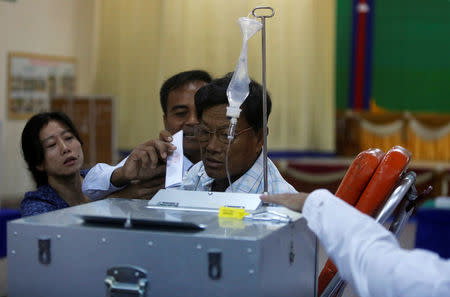 A commune counsellor who is sick casts his ballot during a Senate election in Takhmao, Kandal province, Cambodia February 25, 2018. REUTERS/Samrang Pring