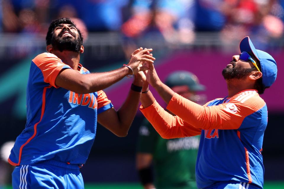 Jasprit Bumrah of India celebrates with teammate Rohit Sharma of India after dismissing Iftikhar Ahmad of Pakistan during the ICC Men's T20 Cricket World Cup West Indies & USA 2024 match between India and Pakistan at Nassau County International Cricket Stadium on June 09, 2024 in New York, New York.