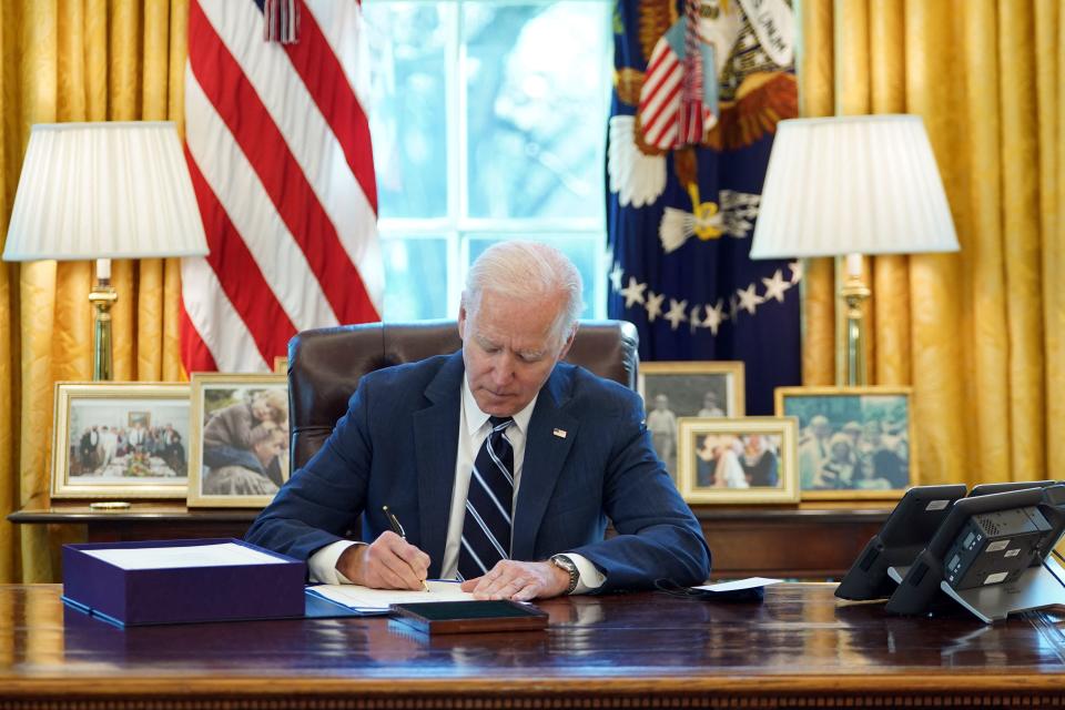 US President Joe Biden signs the American Rescue Plan on March 11, 2021, in the Oval Office of the White House in Washington, DC. - Biden signed the $1.9 trillion economic stimulus bill and will give a national address urging 