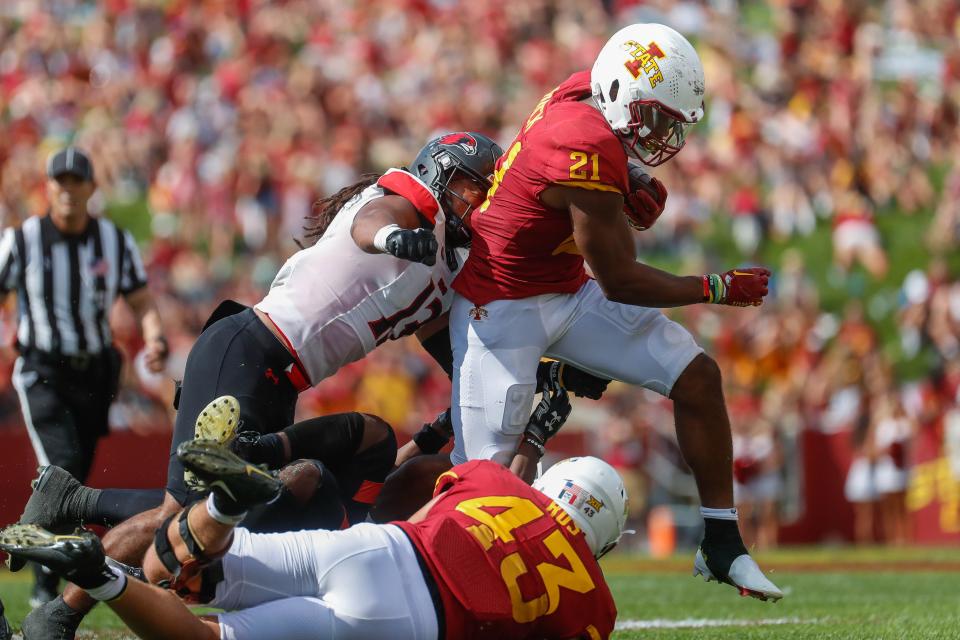 Iowa State running back Jirehl Brock (21) attempts to avoid SEMO inside linebacker Mali Walton (13) on Saturday at Jack Trice Stadium in Ames, Iowa.