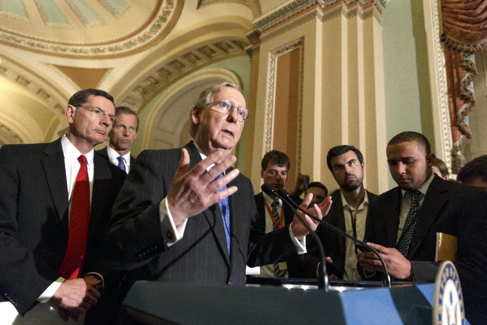 Senate Minority Leader Mitch McConnell, R-Ky., joined by Sen. John Barrasso, R-Wyo., left, and Sen. John Thune, R-S.D., rear left, speaks to reporters after a Republican caucus meeting, at the Capitol in Washington, Tuesday, May 6, 2014. (AP Photo/J. Scott Applewhite)